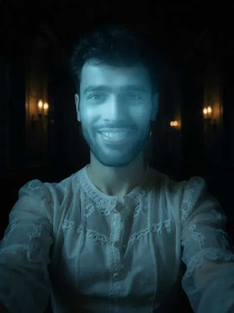 Pale-blue Victorian ghost in a candlelit hallway, AI example